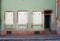 Pastel green and dark brown building with white windows and door