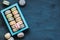 Pastel macaroons box on dark wooden background, copy space