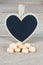 Pastel orange pills with blank heart shape blackboard on wood b