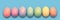 Pastel painted Easter eggs aligned in a row on blue panoramic background Easter web banner