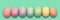 Pastel painted Easter eggs aligned in a row on green panoramic background Easter web banner