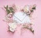 Pastel pink flowers around White envelop , floral arrangement