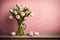 pastel pink monochromatic bouquet of tulips with some tulips on ground on a wooden surface and pink background. elegant floral