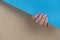 Pastel softness manicured nails on beige blue background. Woman showing her new manicure in colors of pastel palette