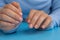 Pastel softness manicured nails on blue background. Woman showing her new manicure in colors of pastel palette