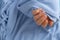 Pastel softness manicured nails on blue sweater background. Woman showing her new manicure in colors of pastel palette