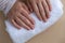 Pastel softness manicured nails on neutral beige background. Woman showing her new manicure in colors of pastel palette