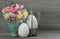 Pastel tulip flowers with vintage easter eggs