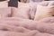 Pastep purple bedding - soft pillows and fur coverlet. coziness, comfort, interior and holidays concept
