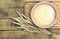 Pastery in a pink bowl with bunch of wheat spikes