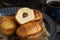 Pasticciotto leccese pastries on a dark blue plate near coffe cup on dark table close up