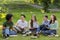 Pastime In Campus. Outdoor portrait of college friends resting after classes together