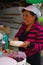 PASTO, COLOMBIA - JULY 3, 2016: unidentified woman preparing a dessert with some wafers, marmalade and coconut