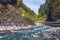 Pastoral in the Alpine mountain valley in Austria. Rapid mountain stream. Mountain river and green forest