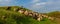 Pastoral scenery with flock of sheep and goats on river bank