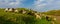 Pastoral scenery with flock of sheep and goats on river bank