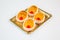 Pastries in a gold tray on white background