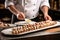 pastry chef arranging cannoli on a dish