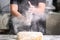 Pastry Chef clapping his hands with flour while making dough