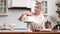 Pastry chef confectioner young caucasian woman with cake on kitchen table.