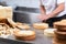 Pastry chef cutting the sponge cake on layers. Cake production process.