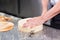 Pastry chef cutting the sponge cake on layers. Cake production process.