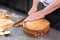 Pastry chef cutting the sponge cake on layers. Cake production process.