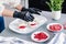 The pastry chef decorates the birds milk souffle cakes with freeze-dried raspberries and strawberries