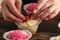 Pastry chef decorates the muffins with fresh strawberries . Cupcakes with berries. Close up