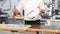 Pastry Chef decorating large festive cake at commercial kitchen.