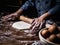 Pastry chef hand kneading Raw Dough with sprinkling white flour