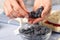 pastry chef lays blueberries on strawberry marshmallow cake