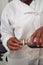 Pastry Chef measuring vanilla essence for cupcake recipe