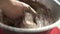 Pastry chef mixes the chocolate and cream in a bowl