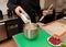 Pastry chef is pouring flour in a bowl