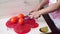 Pastry chef removes excess glazing from individual cakes using a spatula