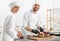 Pastry chefs preparing desserts at table