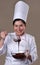 Pastry cook woman tasting chocolate