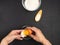 Pastry creation process. A young girl breaks an egg into a transparent bowl, flour, salt