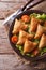 Pastry samosas on a plate close-up. Vertical top view, rustic