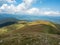 Pasture in Carpathians mountains at summer, west Ukraine. Ukrainian nature landscape in august. Blue sky with big white