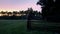 Pasture on country lane at sunset on a farm with cattle gates