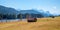 Pasture with wooden hay hut, lake Geroldsee and Wetterstein mountains in spring