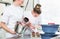 Pasty baker women putting cream on cakes