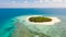 Patawan island. Small tropical island with white sandy beach. Beautiful island on the atoll, view from above