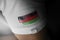 Patch of the national flag of the Malawi on a white t-shirt