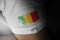 Patch of the national flag of the Mali on a white t-shirt