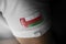 Patch of the national flag of the Oman on a white t-shirt