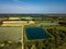 A patchwork of farm field in the Suffolk countryside with a large reservoir in the foreground