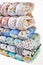 Patchwork and fashion concept - beautiful stack of colorful quilts, bedspreads stacked in several rows in height for storage, sale